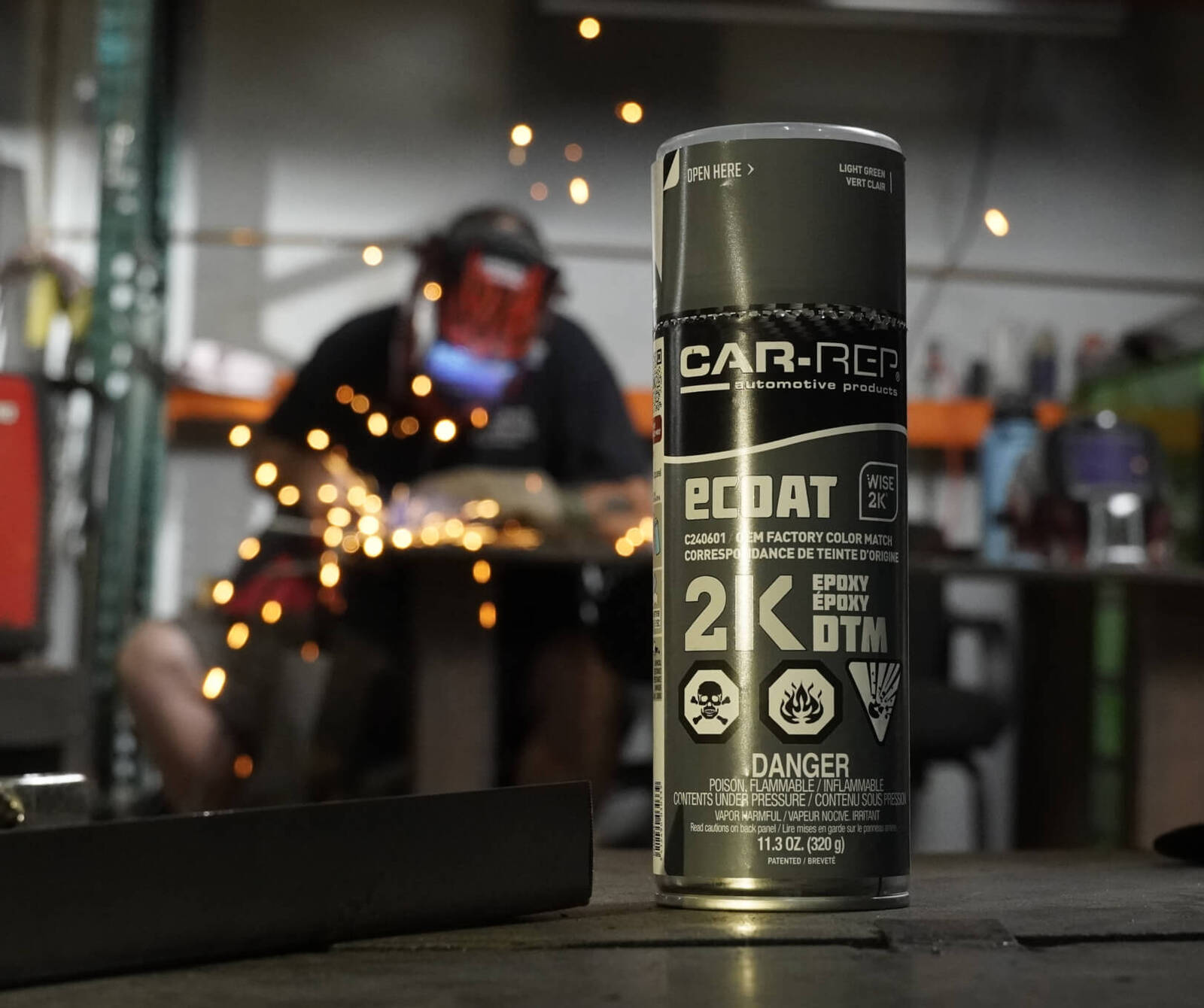 Car-Rep 2K spray paint can sitting on a workbench, ready for use. Car-Rep 2K spray paint can sitting on a workbench, ready for use.