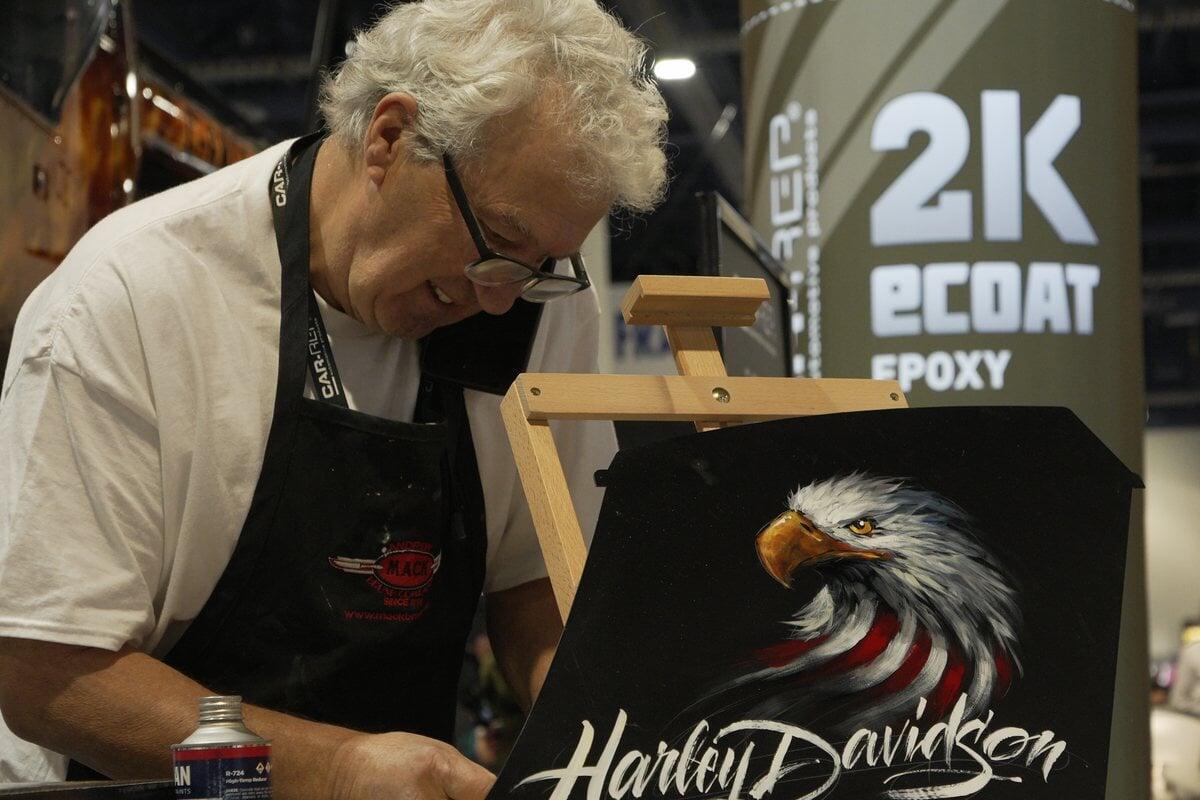 Artist painting live at the Car-Rep booth