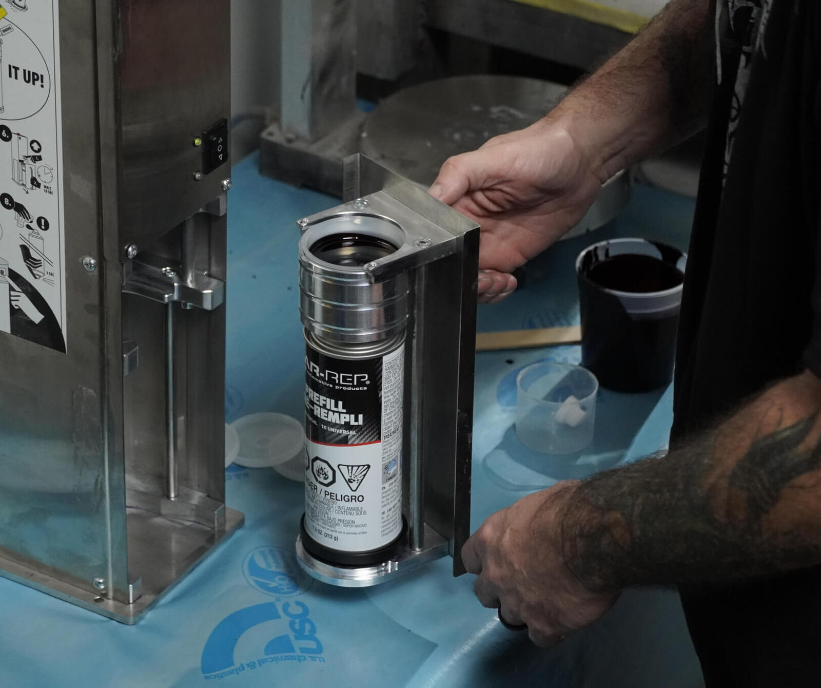 Car-Rep 2K spray paint can sitting on a workbench, ready for use.